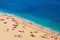 Aerial view on beach and umbrellas. Vacation and adventure. Beach and blue water. Top view from drone at beach and azure sea.