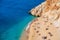 Aerial view on beach and umbrellas. Vacation and adventure. Beach and blue water. Top view from drone at beach and azure sea.