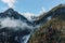 Aerial view of beautiful autumn forest on slope of alpine mountains