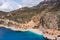 Aerial view of a beautiful bay with a beach and turquoise sea among big mountains. Kaputas beach, Kas, Türkiye.