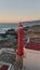 Aerial view beautiful beacon standing on stony seaside at summer twilight.