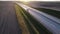 Aerial view of a beautiful country expressway with a small cargo van passing by at dawn. The concept of freight