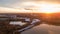 Aerial view of a beautiful and dramatic Setting sun with a view, and sunset reflection on a lake, landscape drone shot