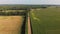 Aerial view of beautiful farm fields and a dirt road.