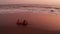 Aerial view of beautiful girl in bikini on the black beach at sunset