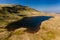 Aerial view of a beautiful glacier-formed lake at the foot of a mountain Llan y fan Fawr