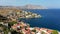 Aerial view of the beautiful greek island of Symi Simi with colourful houses and small boats. Greece, Symi island, view of the