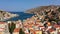 Aerial view of the beautiful greek island of Symi Simi with colourful houses and small boats. Greece, Symi island, view of the