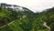 Aerial view of beautiful hilly landscape with winding roads in Asian countryside.