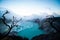 Aerial view of beautiful Ijen volcano with acid lake and sulfur gas going from crater