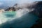 Aerial view of beautiful Ijen volcano with acid lake and sulfur gas going from crater