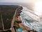 Aerial view of a beautiful isolated road with vehicles driving along south Portuguese coastline facing the Atlantic Ocean rough