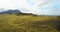 Aerial view of the beautiful landscape, the green lava field in Iceland. Drone flying over the cliffs covered with moss.