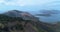 Aerial view of a beautiful landscape, sea, islands, green mountain slope in a summer journey. Drone point of view of