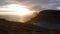 Aerial view of beautiful orange sunset in Faroe Island. Huge cliff and sea stacks glow in golden evening light