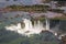 Aerial view of beautiful rainbow above Iguazu Falls Devil`s Throat chasm from a helicopter flight. Brazil and Argentina.