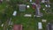 Aerial view of a beautiful Russian village on a cloudy summer day. Wooden houses. Country life.