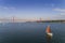 Aerial view of a beautiful sail boat on the Tagus River with the 25 of April Bridge on the background, in the city of Lisbon