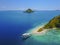 Aerial view of beautiful scenery at Flores island with tourist yatch, turqouise and dark blue sea