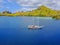 Aerial view of beautiful scenery at Flores island with tourist yatch, turqouise and dark blue sea