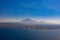 Aerial view of beautiful seascape with boats over island with volcano background in Indonesia