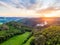 Aerial view of beautiful sunset over the Karlstejn castle, Czech Republic. Drone shot of ancient castle with near forest. Castle