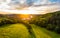 Aerial view of beautiful sunset over the Karlstejn castle, Czech Republic. Drone shot of ancient castle with near forest. Castle