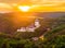 Aerial view of beautiful sunset over the Karlstejn castle, Czech Republic. Drone shot of ancient castle with near forest. Castle