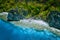 Aerial view of beautiful tropical limestone rocks, blue ocean and coral reef edge at El Nido, Palawan, Philippines