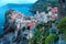 Aerial view of beautiful Vernazza in early morning light, an amazing village of colorful houses perched on rocky cliffs