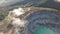 Aerial view of beautiful volcanic landscape and acid lake with clouds near Ijen volcano