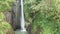 Aerial view of beautiful waterfall in green tropical rain forest in Bali