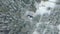 Aerial view of a beautiful winter landscape with snow covered green forest and a small house. Clip. Shelter for hunters