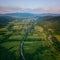 Aerial view of the beautiful wooded Carpathian mountains and small village, summer landscape