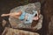 Aerial view on beautiful young ginger caucasian woman laying on stone by lake in summer .Happy Woman Enjoying Nature Outdoor. Free