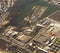 Aerial view below an airplane wing equipped with winglet : flying over residential, suburban and industrial zones of the region of