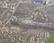 Aerial view below an airplane wing equipped with winglet : flying over residential, suburban and industrial zones of the region of