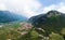 Aerial view of Besenello town and northern vineyards, Trento, Italy, beautiful wide panorama of mountain city near the mountains