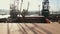 Aerial view of big cargo ship bulk carrier is loaded with grain of wheat in port at sunset