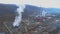 Aerial view of big copper smelter and refinery factory with smoking pipes in cloudy day