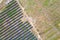 Aerial view of big electric power plant construction with many rows of solar panels on metal frame for producing clean ecological