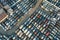 Aerial view of big parking lot of junkyard with rows of discarded broken cars. Recycling of old vehicles