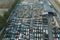 Aerial view of big parking lot of junkyard with rows of discarded broken cars. Recycling of old vehicles