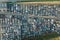 Aerial view of big parking lot of junkyard with rows of discarded broken cars. Recycling of old vehicles