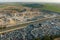 Aerial view of big parking lot of junkyard with rows of discarded broken cars. Recycling of old vehicles