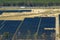 Aerial view of big sustainable electric power plant with many rows of solar photovoltaic panels for producing clean