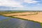 Aerial view of big sustainable electric power plant with many rows of solar photovoltaic panels for producing clean