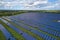 Aerial view of big sustainable electric power plant with many rows of solar photovoltaic panels for producing clean