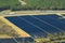 Aerial view of big sustainable electric power plant with many rows of solar photovoltaic panels for producing clean