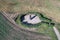 Aerial view of the biggest petrified shepherd Menhir stone standing in a field in the Czech republic